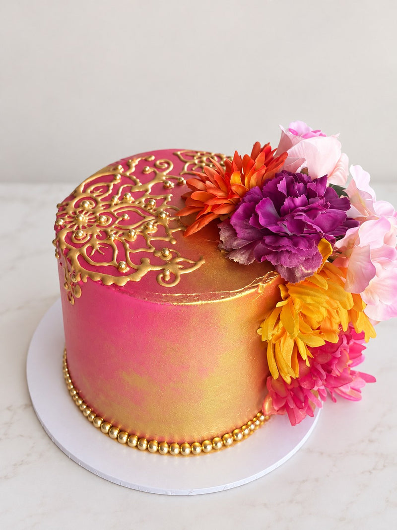 Pink and gold henna cake with flowers