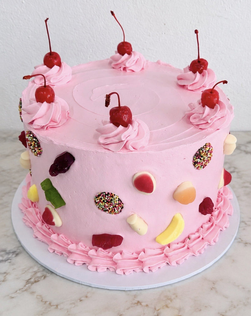 Pink lolly cake with cherries