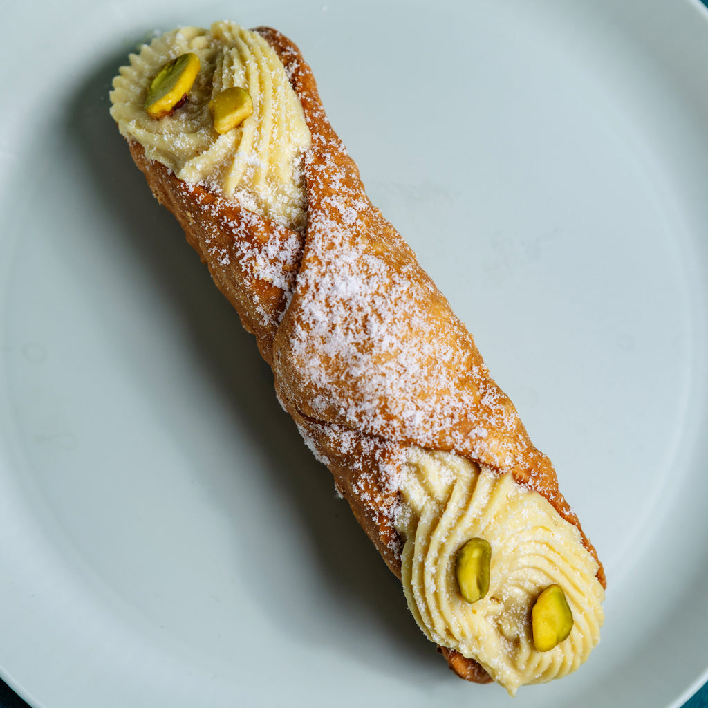 Pistachio cannolo with pistachio cream and chopped pistachios, dusted with icing sugar, Milano Cakes Wollongong