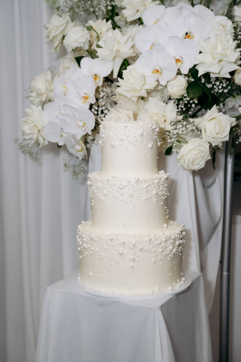 Three-tier pearl wedding cake with orchids